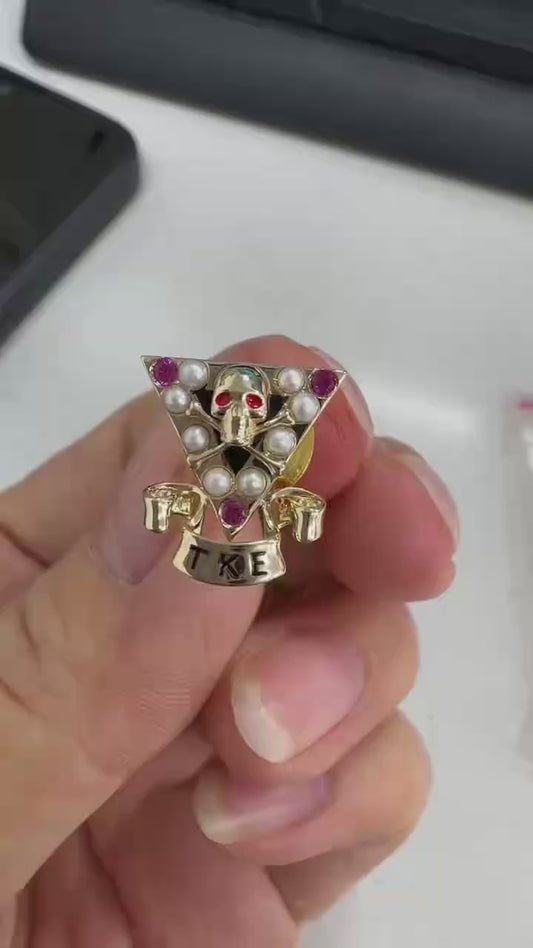Custom make triangle skul pin with lab ruby and freshwater pearls in 10k yellow gold